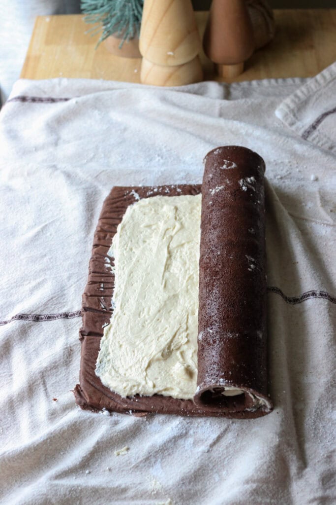  freshly milled chocolate yule log cake that has been filled with cream and rolled up