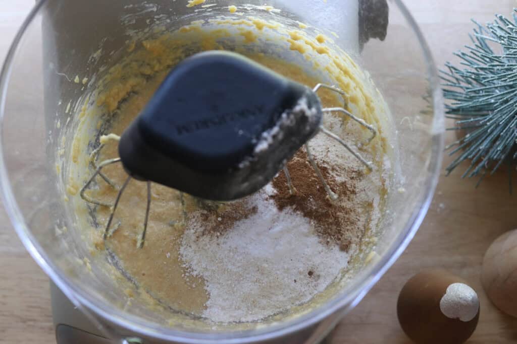 flour and spices in a mixing bowl to make Fresh Milled Eggnog Cupcakes with Cream Cheese Icing