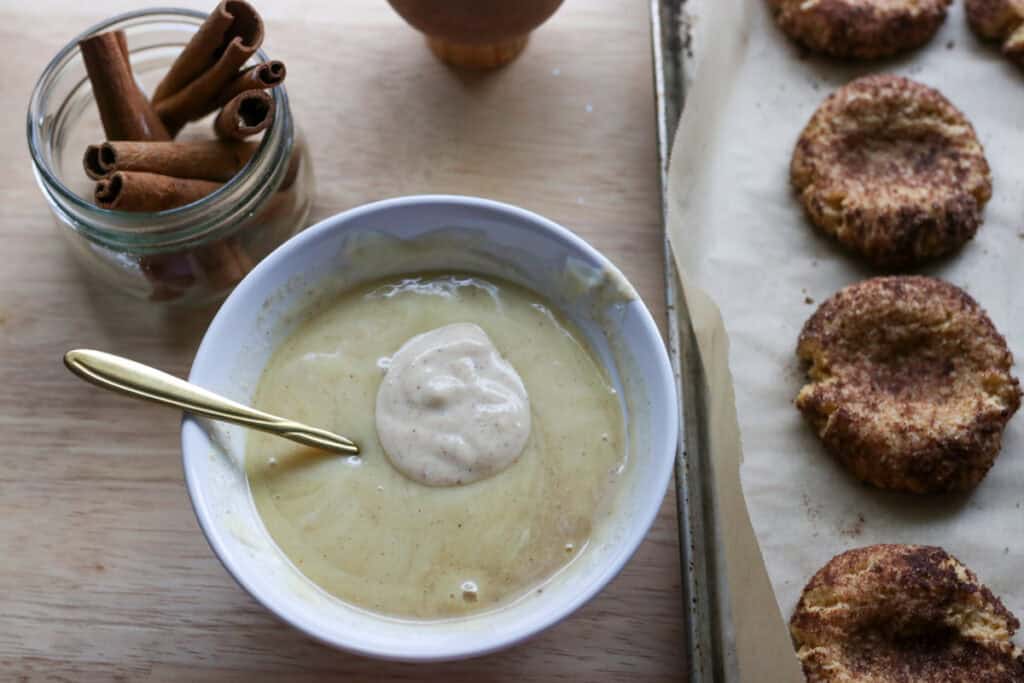 eggnog and white chocolate in a bowl to make the filling for fresh milled eggnog snickerdoodle thumbprint cookies