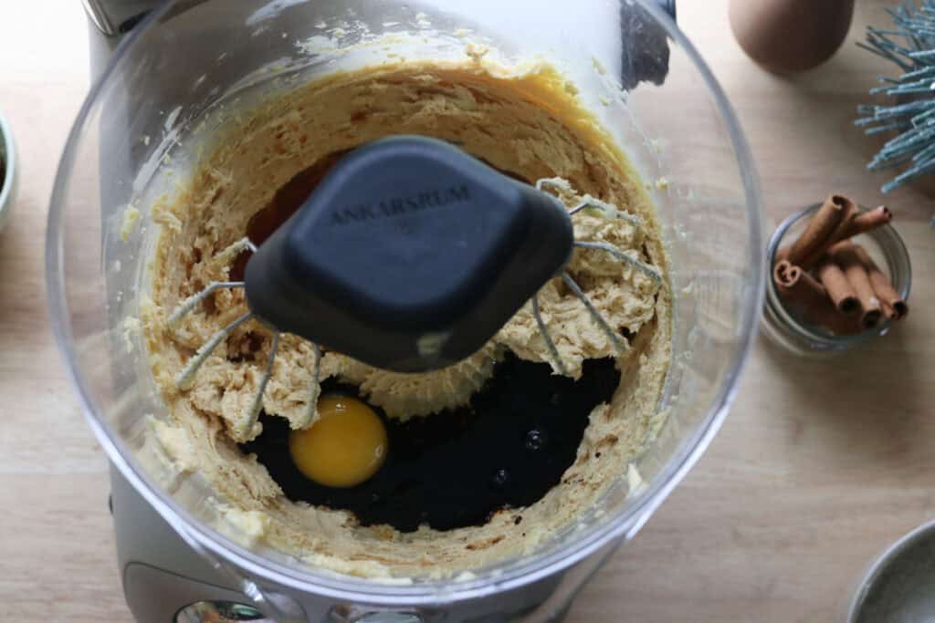 egg and vanilla added to a mixing bowl to make freshly milled gingerbread crinkle cookies