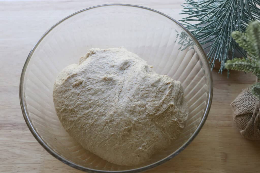 the dough for Easy Garlic Herb Focaccia with Fresh Milled Flour in a glass bowl 