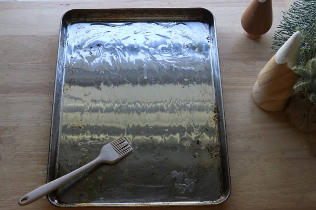 a baking sheet covered in oil to stretch out the dough for Easy Garlic Herb Focaccia with Fresh Milled Flour