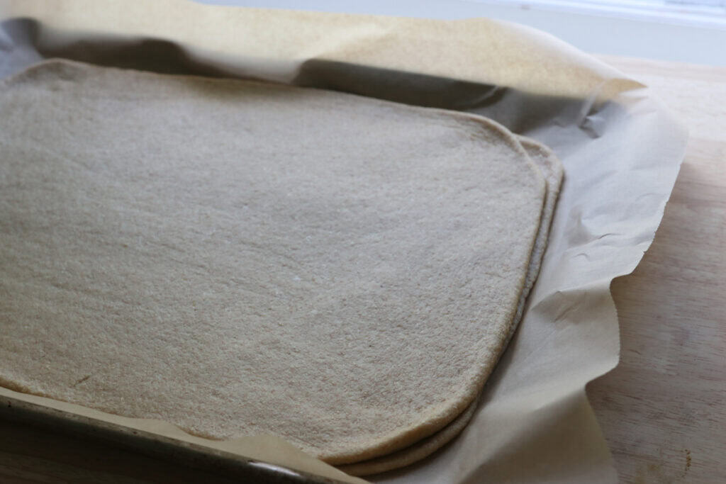 two pieces of dough in a rectangle shape stacked together to make Fresh Milled Christmas Tree Garlic and Herb Bread