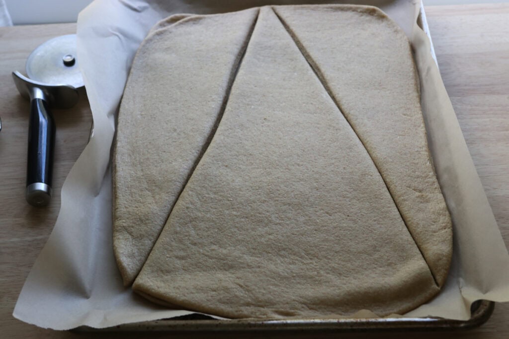 dough that has been cut in a triangle shape for the Fresh Milled Christmas Tree Garlic and Herb Bread