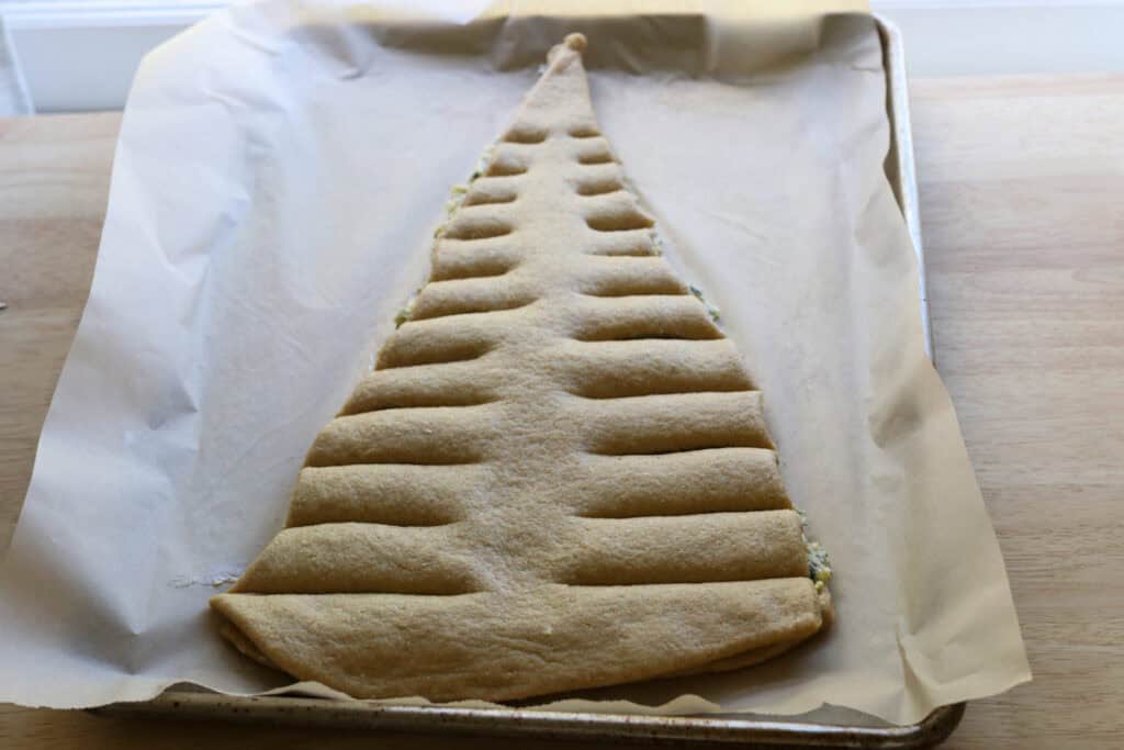 dough that has been cut in the shape of a Christmas tree to make Fresh Milled Christmas Tree Garlic and Herb Bread