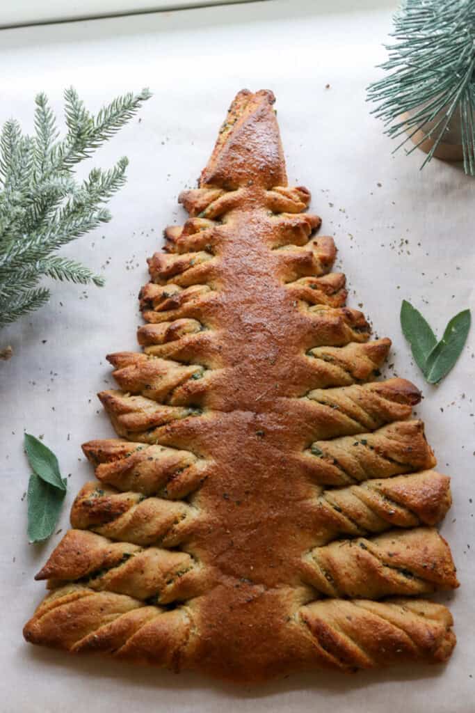 Fresh Milled Christmas Tree Garlic and Herb Bread on white parchment with herbs on top