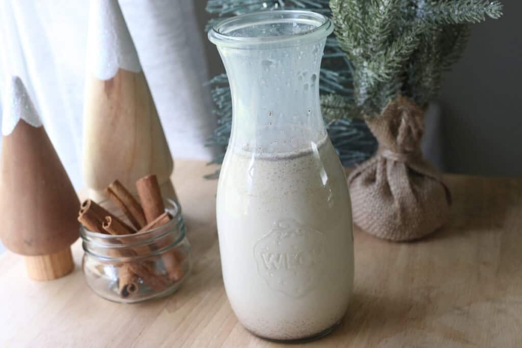 Delicious Healthier Teddy Graham Coffee Creamer in a glass jar with trees behind it