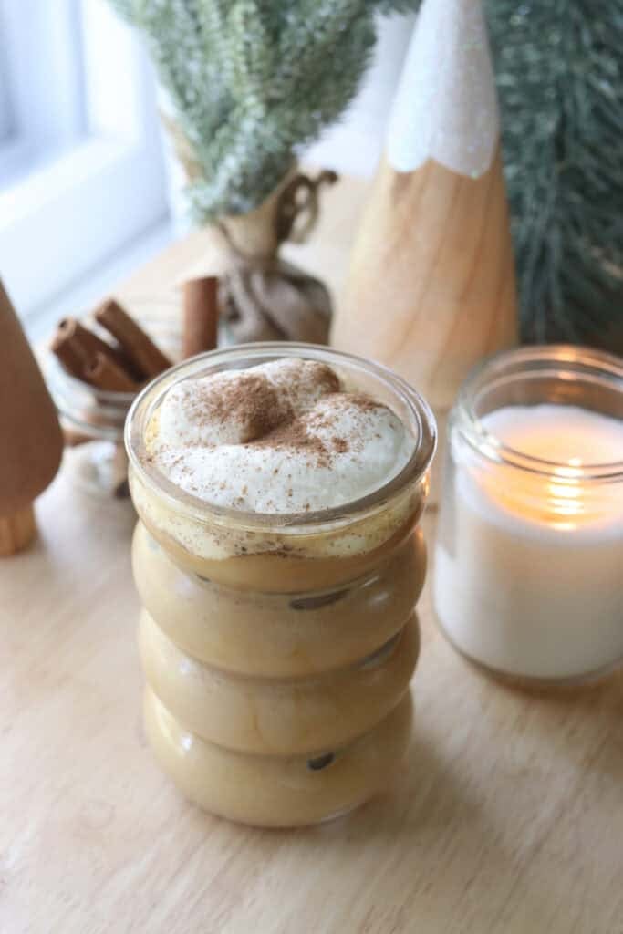 coffee with Delicious Healthier Teddy Graham Coffee Creamer in it and a candle behind it