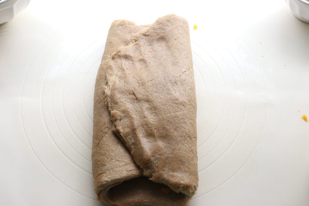 fresh milled Christmas Stollen bread folded up on a mat