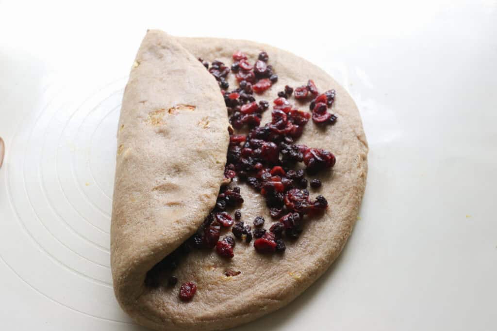 fresh milled Christmas Stollen dough filled with dried fruit and folded in half