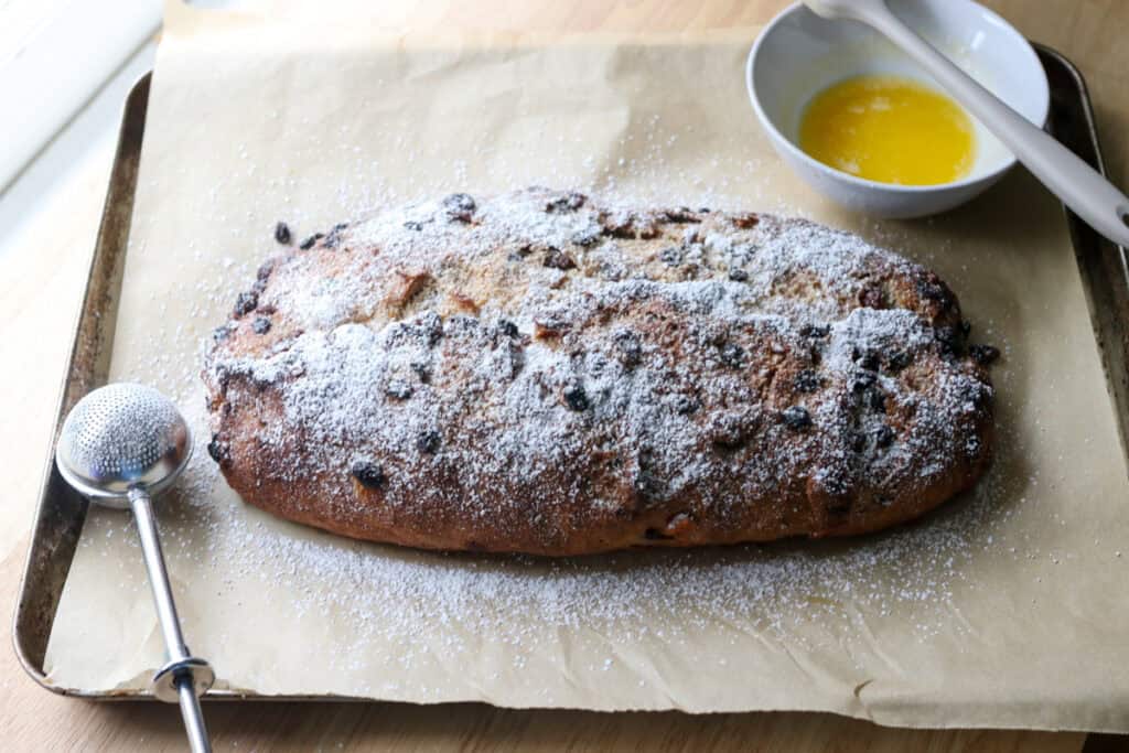 fresh milled Christmas Stollen bread brushed with butter and covered in powdered sugar