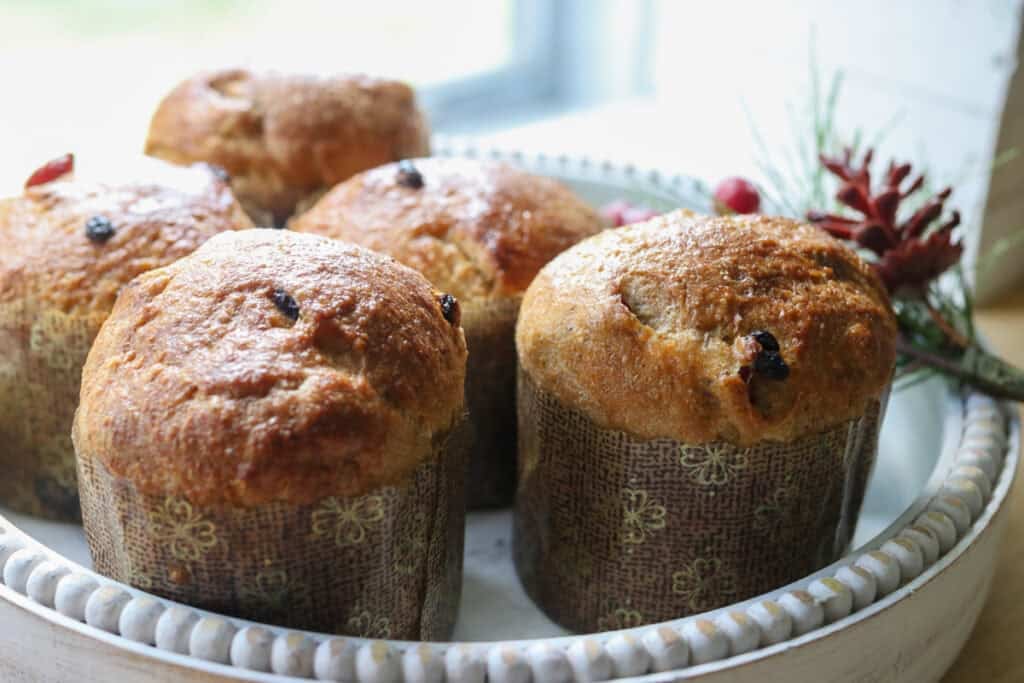 Homemade Mini Panettones with Fresh Milled Flour on a white tray with berries