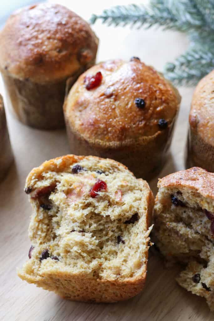 a homemade fresh milled mini panettone torn in half with cranberries and currants in the middle