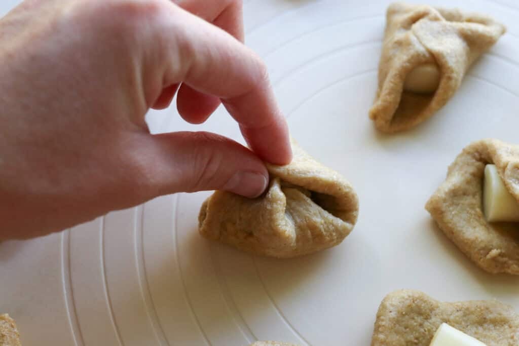 pinching the ends of fresh milled dough together