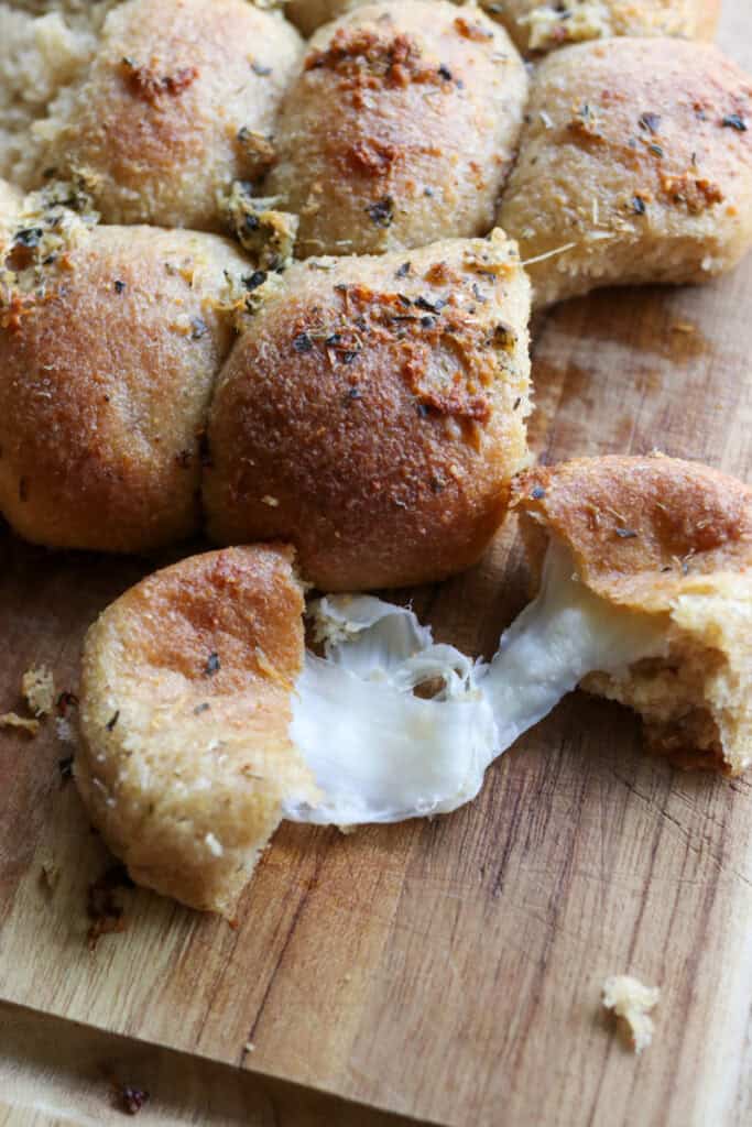 Fresh Milled Cheesy Pull-Apart Christmas Tree Bread torn in half with cheese coming out of it