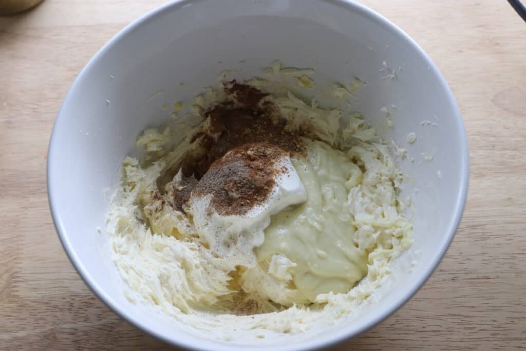 white chocolate, cinnamon, and ginger in a mixing bowl to mix No-Bake Mini Christmas Gingerbread Cheesecake Cups