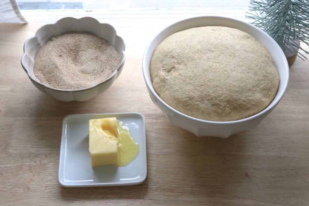 fresh milled cinnamon sugar star bread that has risen in a bowl with butter and sugar