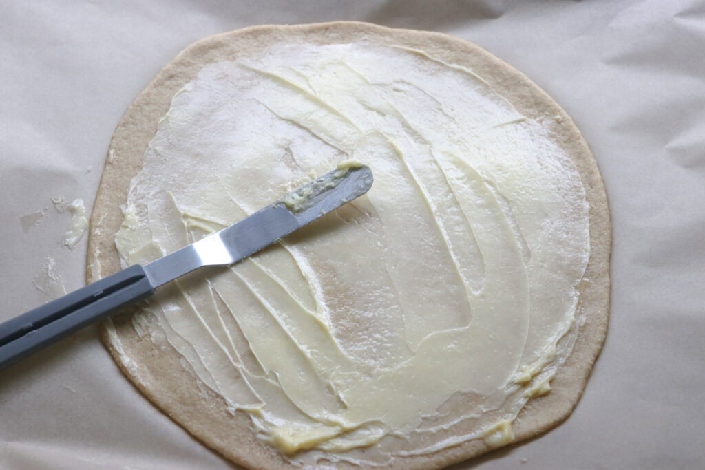 fresh milled cinnamon sugar star bread rolled into a circle and spread with butter
