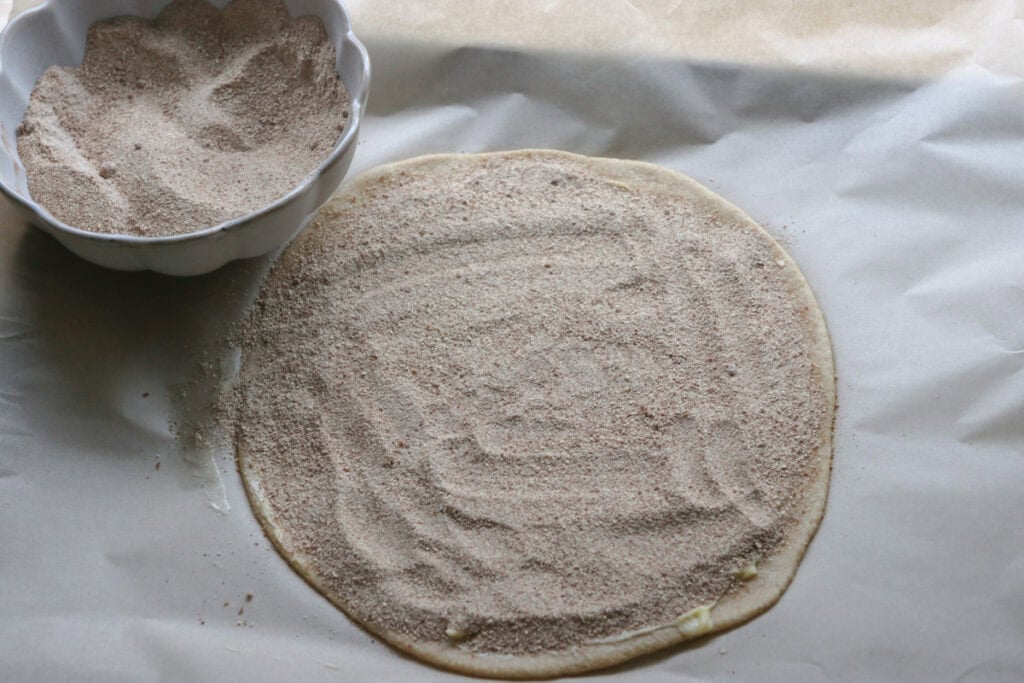 fresh milled cinnamon sugar star bread rolled into a circle and sprinkled with cinnamon and sugar