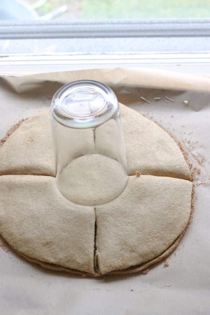 fresh milled cinnamon sugar star dough with a glass in the center and four cuts in it