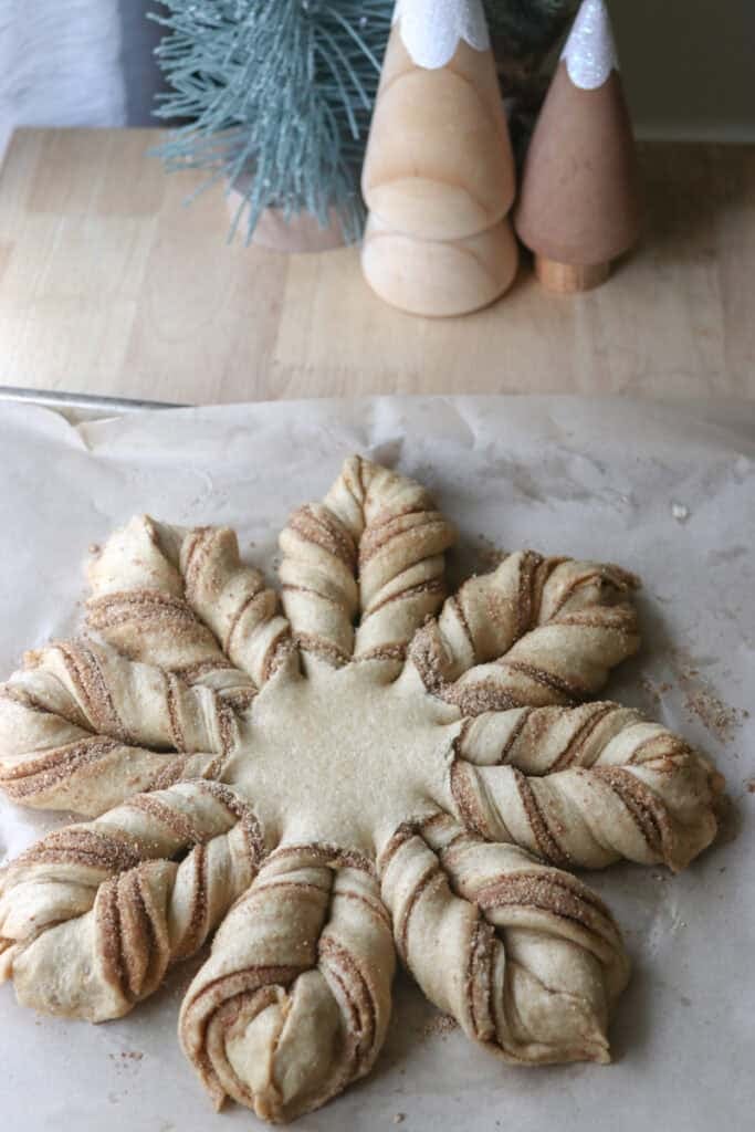 fresh milled cinnamon sugar star bread on a piece of parchment paper waiting to be baked