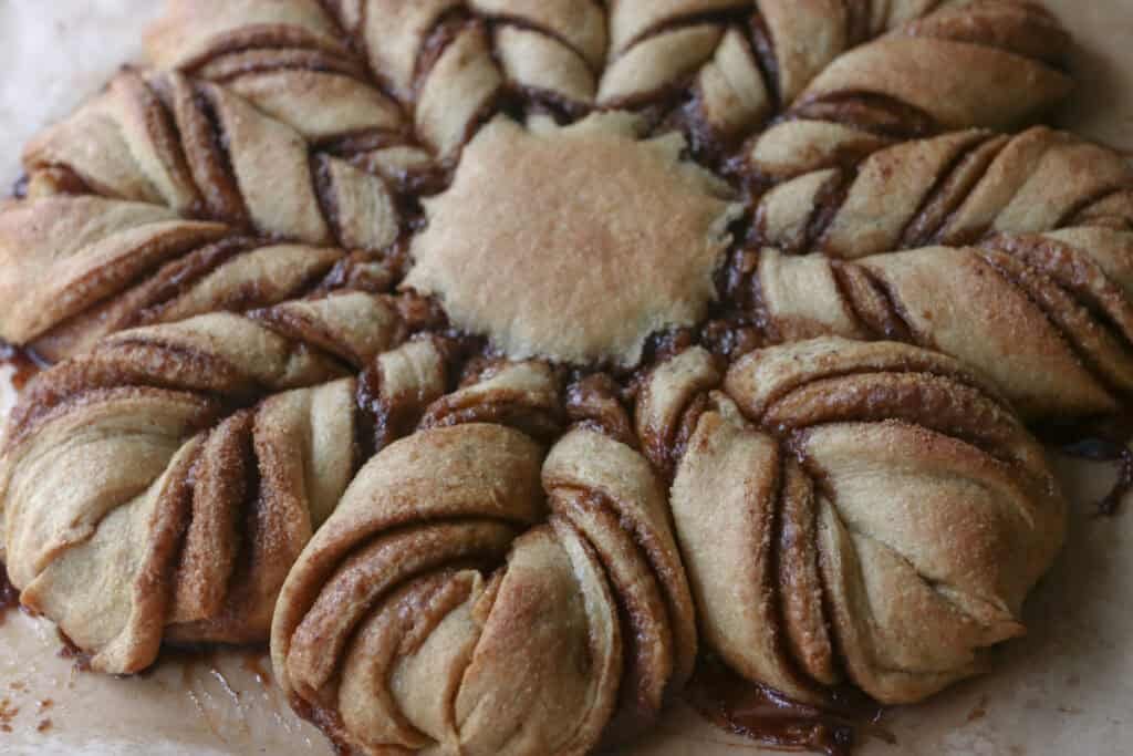 fresh milled cinnamon sugar star bread on a piece of parchment paper
