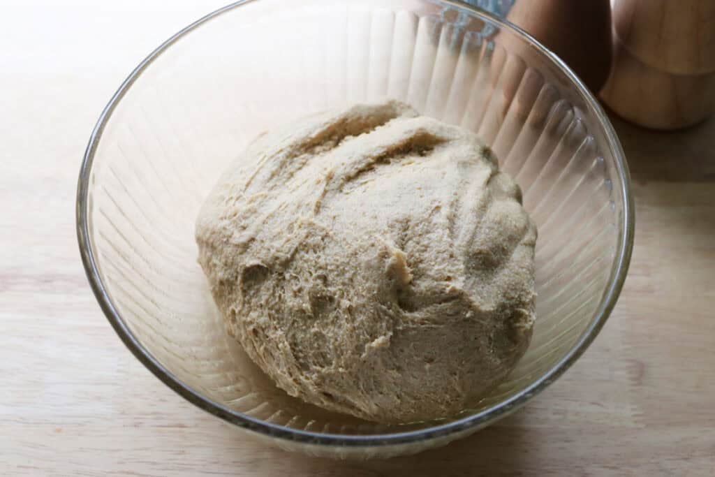 fresh milled fluffy Christmas dinner roll dough in a glass bowl