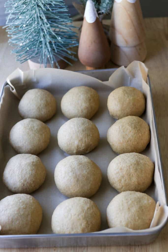 fresh milled fluffy Christmas dinner rolls divided into 12 rolls in a pan