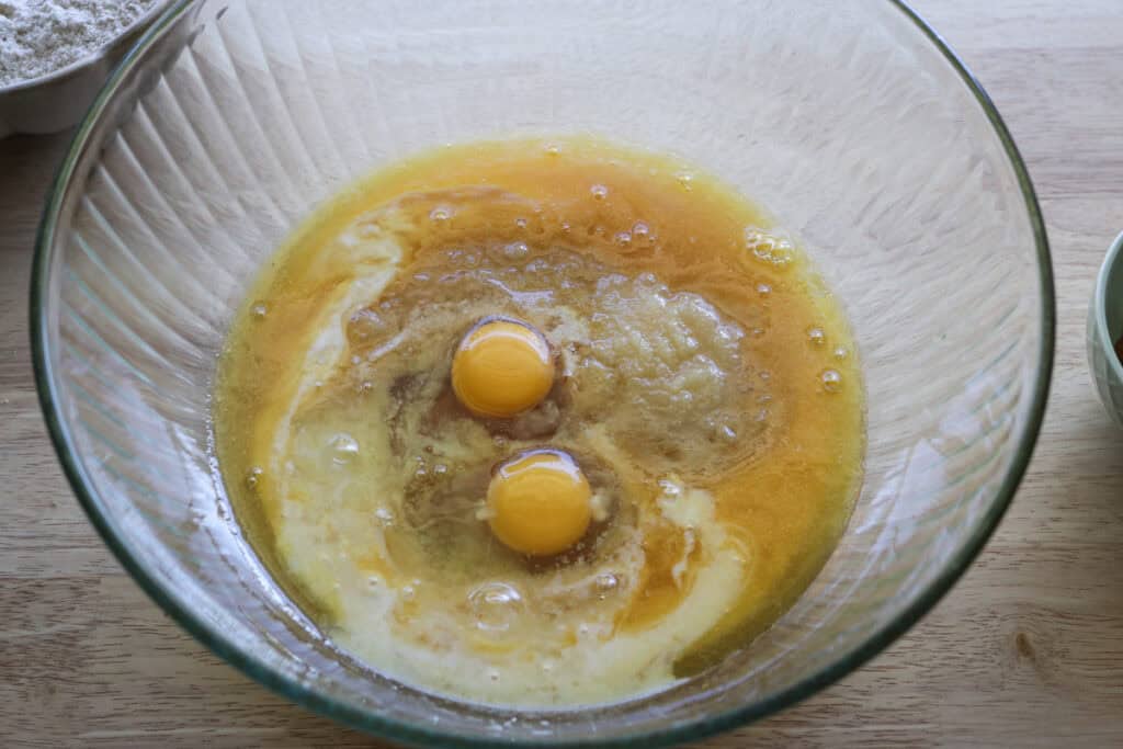 eggs and applesauce in a bowl to make fresh milled apple cider donuts