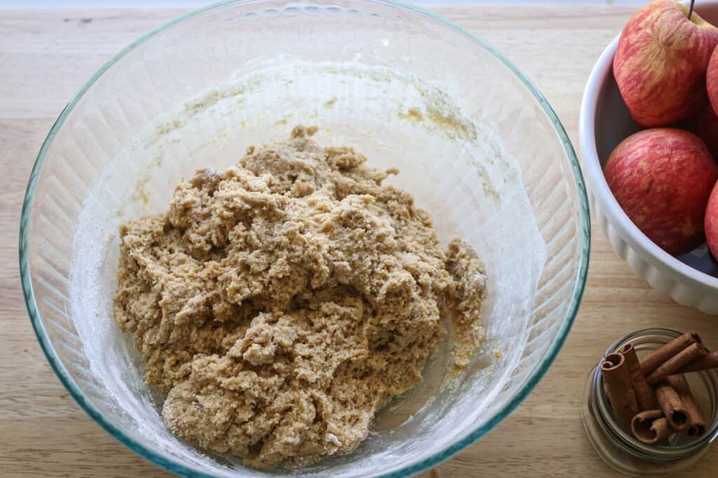 fresh milled apple cider donut dough in a glass bowl