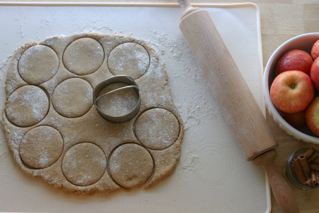 fresh milled apple cider donuts that has been rolled out and pressed with a biscuit cutter