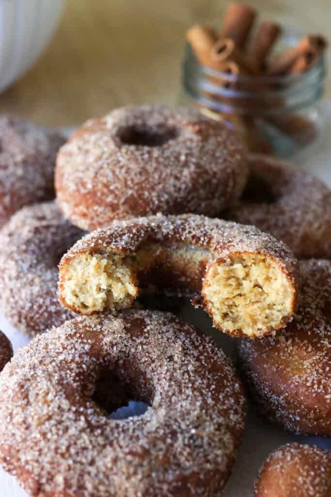 fresh milled apple cider donuts with one cut in half