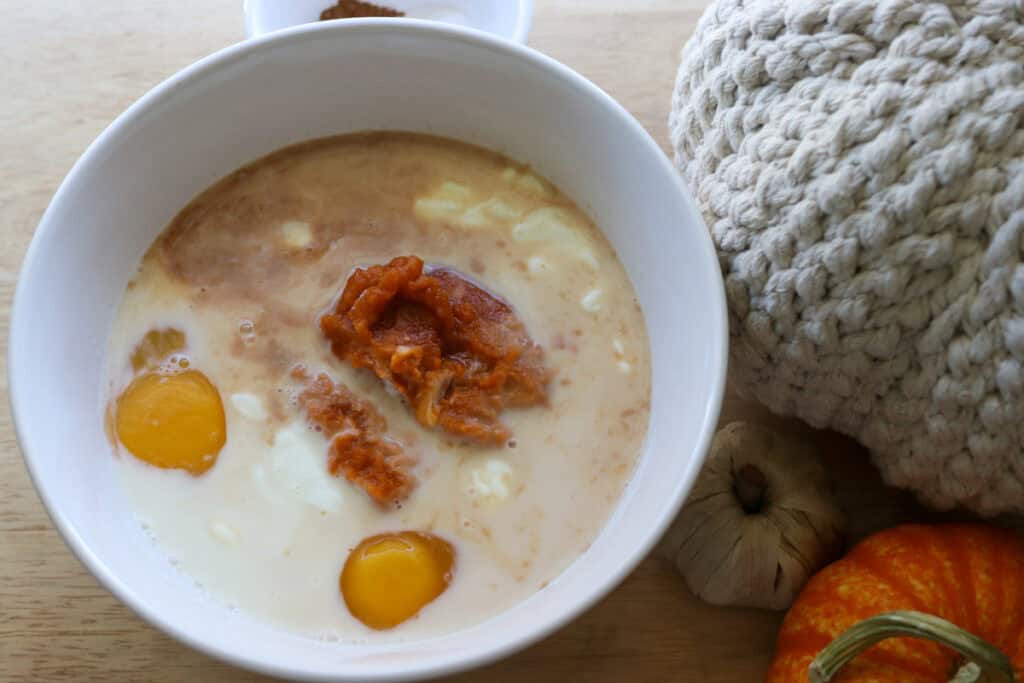 eggs, pumpkin and milk in a bowl to make Healthy High Protein Baked Pumpkin Spice Oatmeal