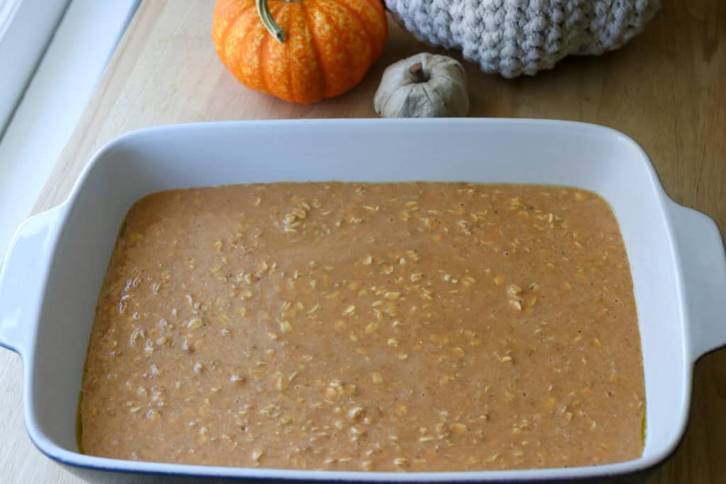 Pumpkin spice oatmeal batter poured into a greased dish