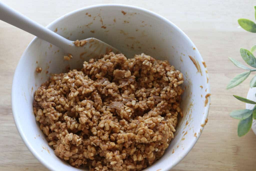 rice krispie mixture in a white bowl to make Chocolate Peanut Butter Rice Krispie Bars