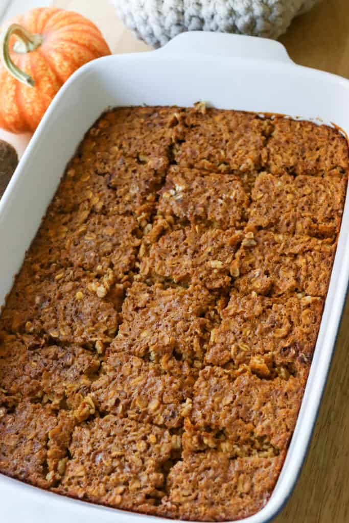 Healthy High Protein Baked Pumpkin Spice Oatmeal that has been cut in a baking dish
