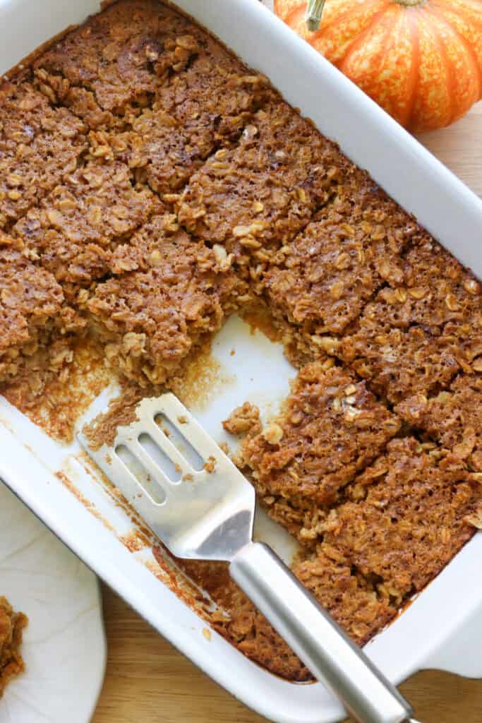 Healthy High Protein Baked Pumpkin Spice Oatmeal in a casserole dish with a spatula