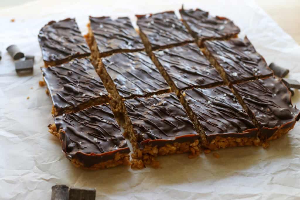 Chocolate Peanut Butter Rice Krispies cut into bars on parchment paper 