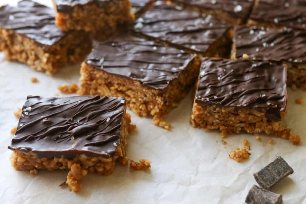 chocolate covered peanut butter rice krispie bars with chocolate chunks topped with flaky salt