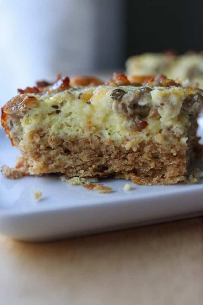 a slice of breakfast casserole with fresh milled biscuits on the bottom and eggs on top 