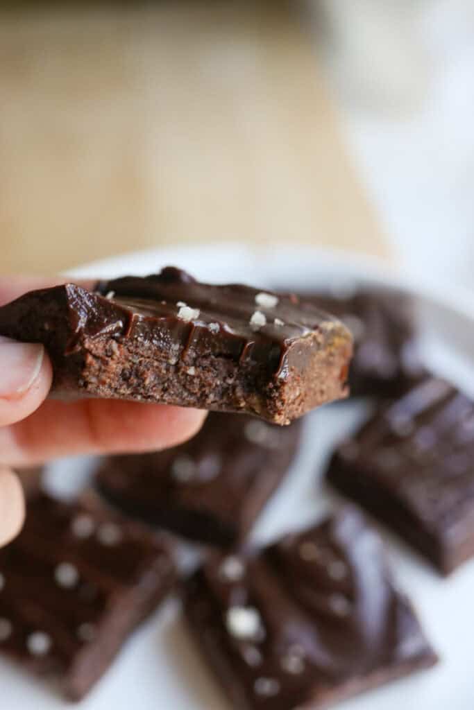 a No Bake Protein Brownie with Chocolate Ganache and bite taken out of it