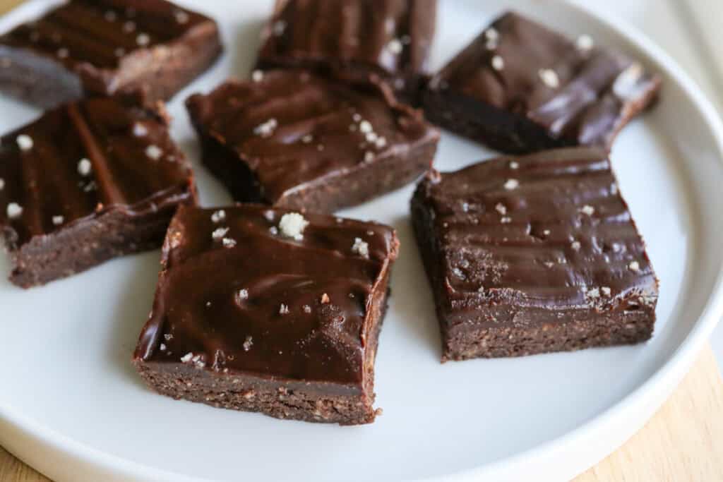 No Bake Protein Brownies with Chocolate Ganache on a white plate