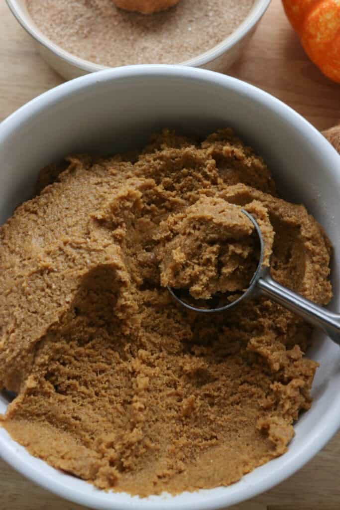 Freshly Milled Brown Butter Maple Pumpkin Cookie dough in a bowl with a cookie scoop