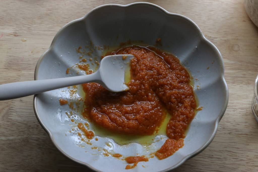 maple syrup and pumpkin puree in a bowl to make The Best Crunchy Maple Pumpkin Spice Granola