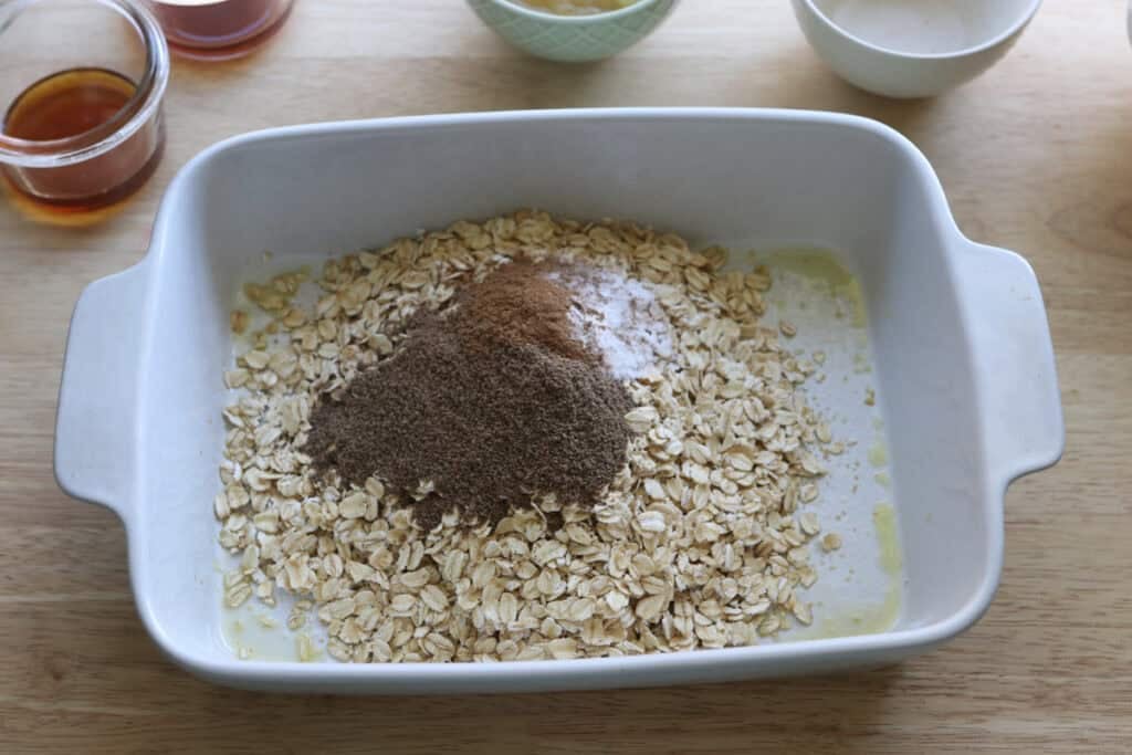 oats and spices in a dish to make Healthy Cinnamon Coffee Cake Baked Oatmeal