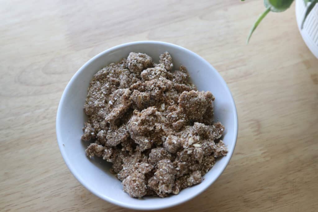 crumble topping in a white bowl to go on top of Healthy Cinnamon Coffee Cake Baked Oatmeal 