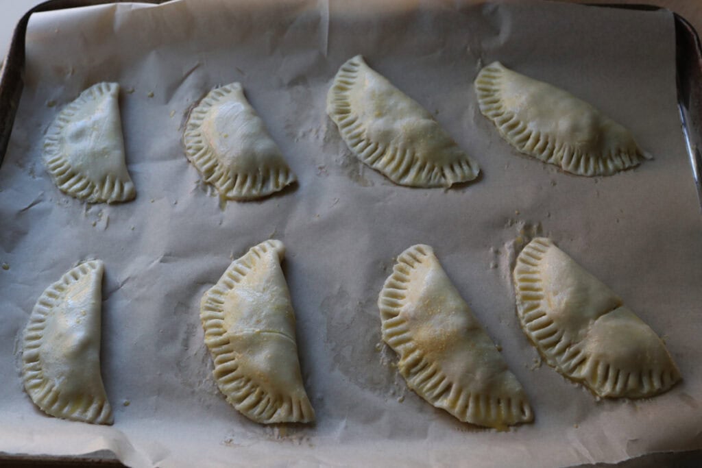 freshly milled healthy apple hand pies on a baking sheet