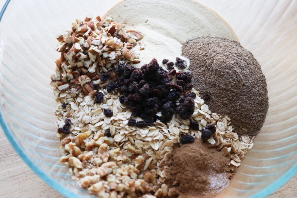the ingredients to make Healthy and Crunchy Protein-Packed Granola in a glass bowl