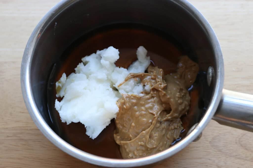 coconut oil and cashew butter in a saucepan to make Healthy and Crunchy Protein-Packed Granola