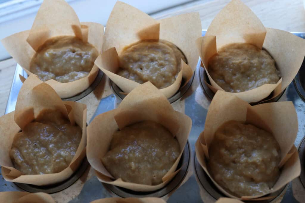 high protein banana muffin batter in a muffin tin